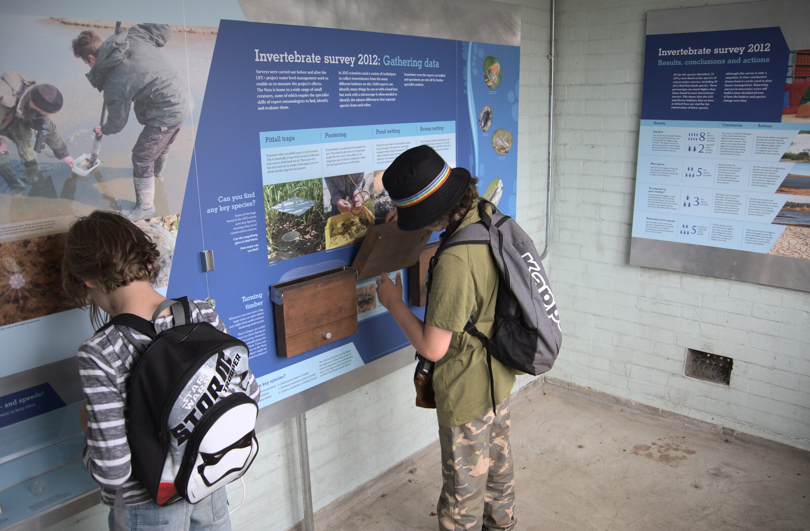 The boys poke around in the information centre from A Trip to Orford Ness, Orford, Suffolk - 16th August 2022