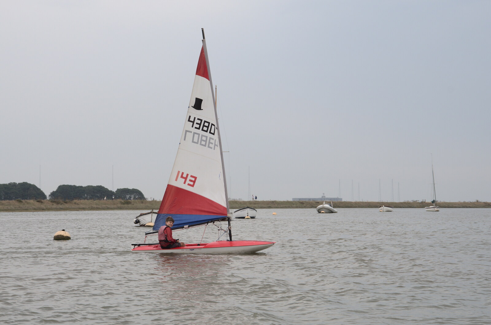 A boy sails a Topper across the river from A Trip to Orford Ness, Orford, Suffolk - 16th August 2022