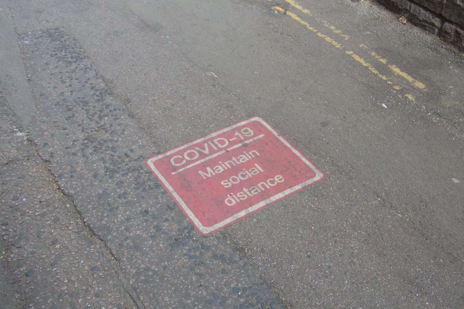 A Covid-19 sign remains on the tarmac, from Anglesey Abbey and a #StandWithUkraine Demo, Cambridge - 24th August 2022