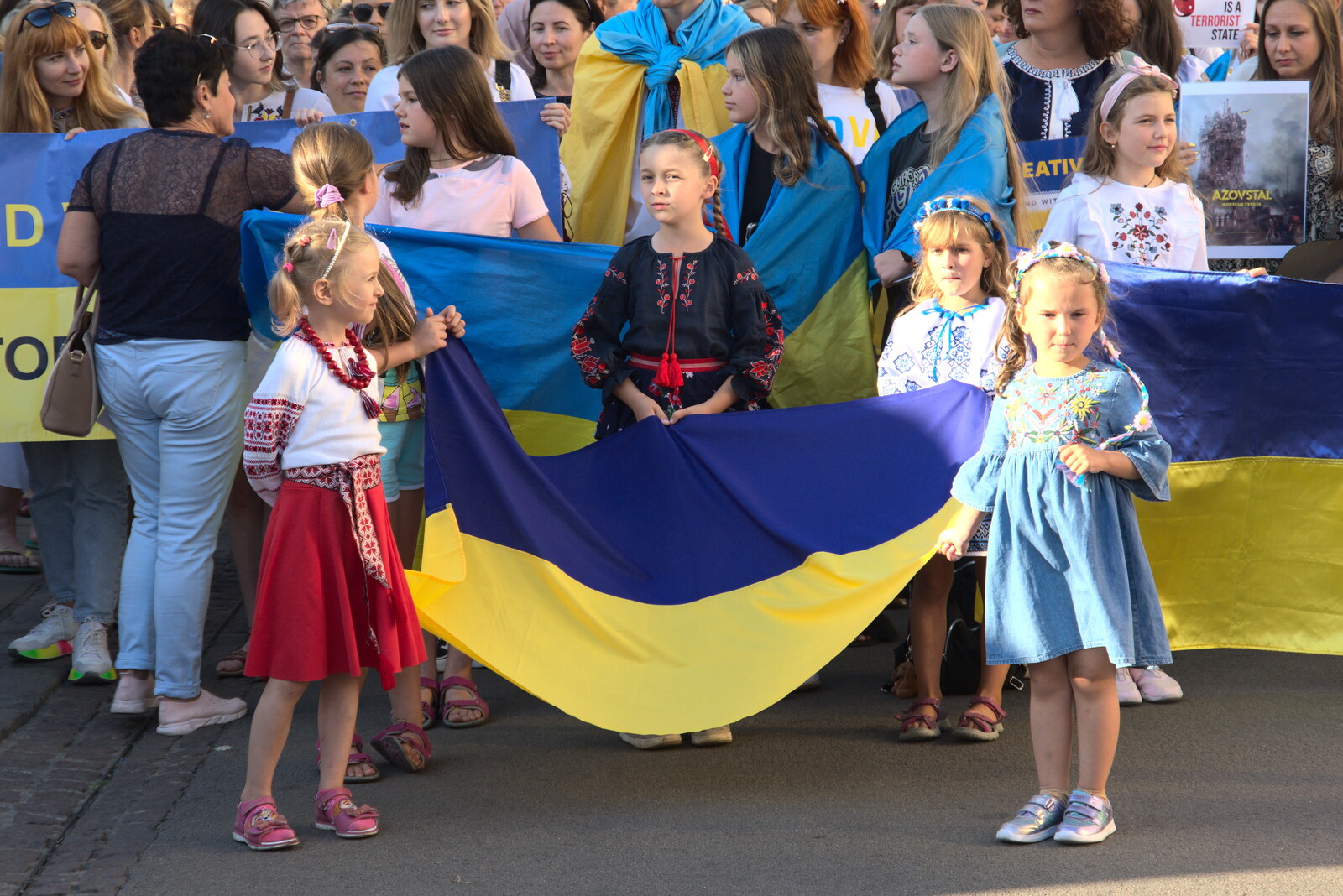 Girls in national dress hold a Ukrainian flag from Anglesey Abbey and a #StandWithUkraine Demo, Cambridge - 24th August 2022