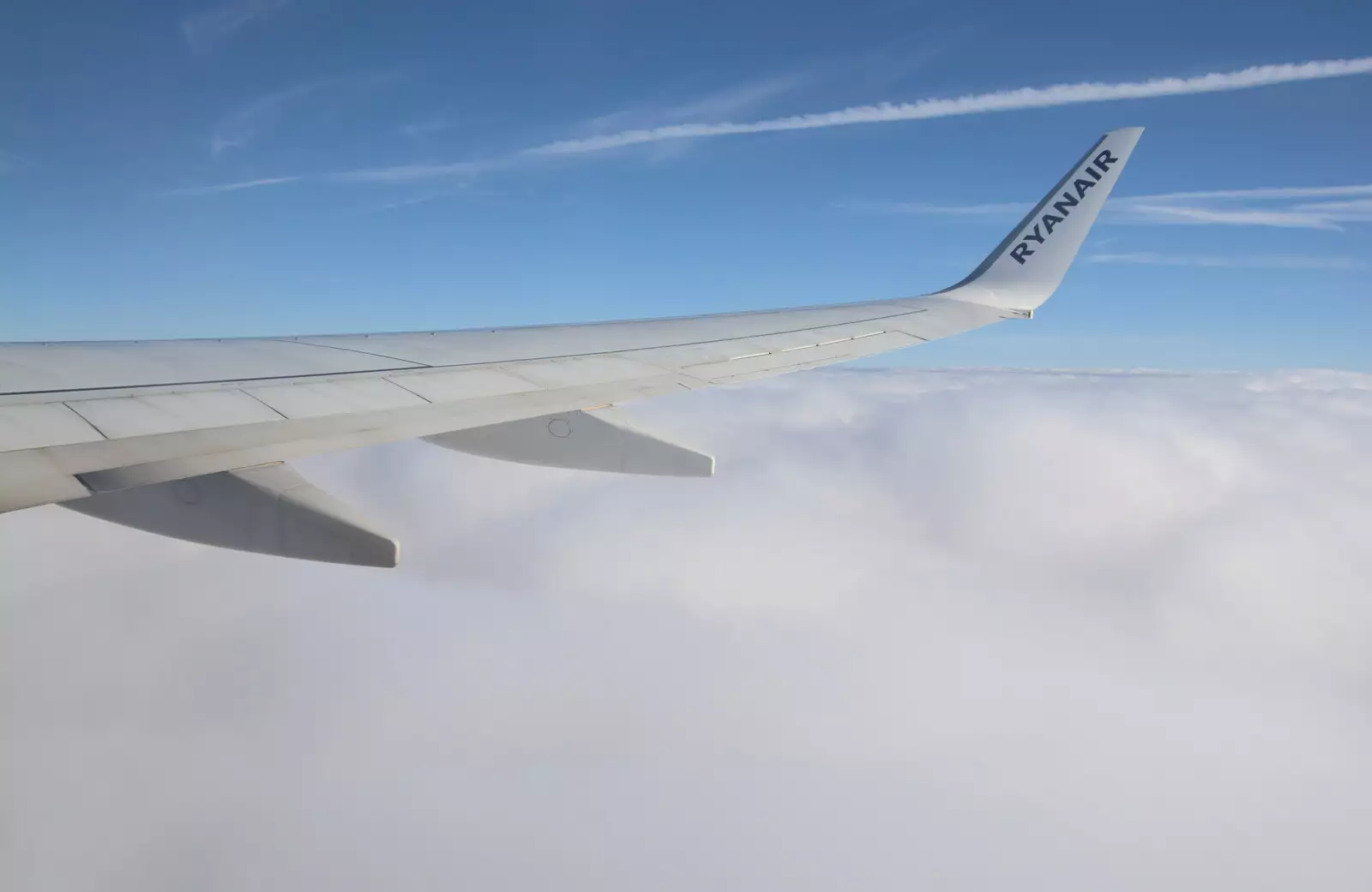 The plane breaks through the layer of clouds, from The Flags of Arezzo, Tuscany, Italy - 28th August 2022