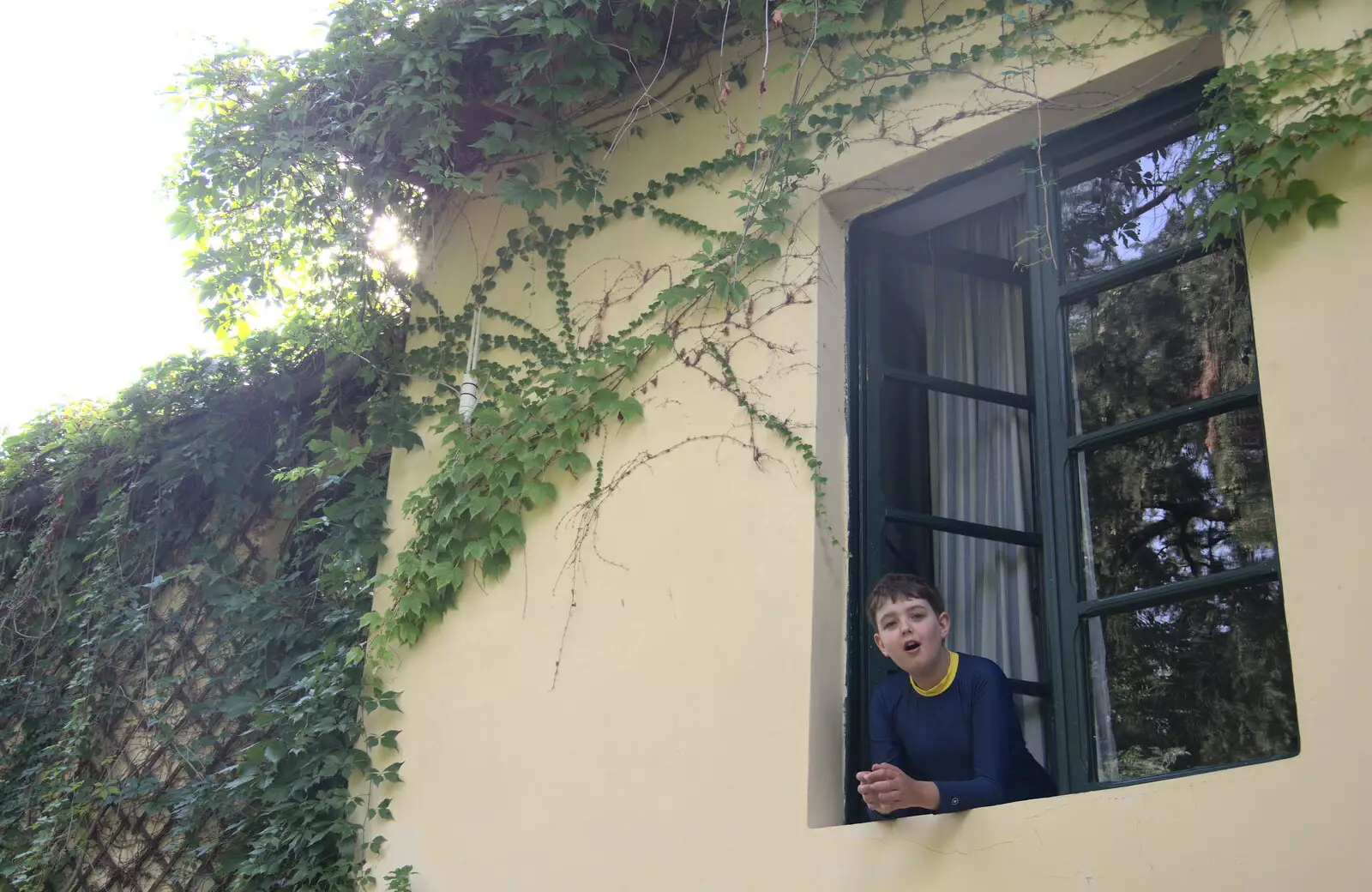 Fred leans out of the boys' bedroom window, from The Flags of Arezzo, Tuscany, Italy - 28th August 2022