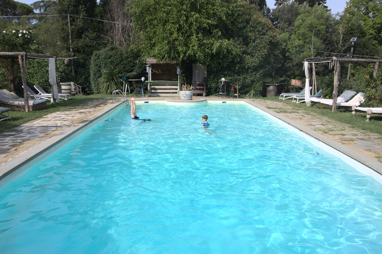 The Flags of Arezzo, Tuscany, Italy - 28th August 2022: The boys are loving the pool