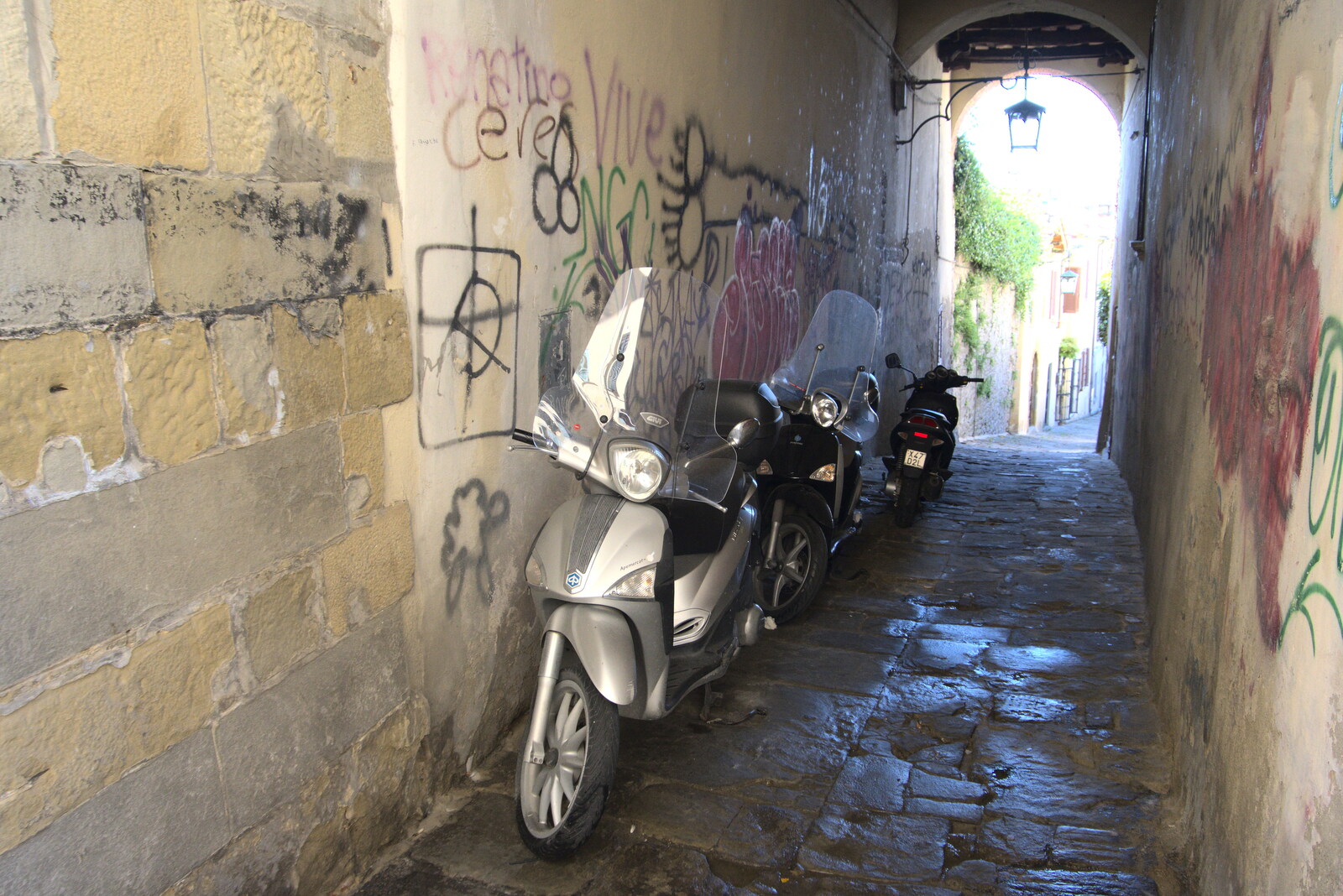 The Flags of Arezzo, Tuscany, Italy - 28th August 2022: Mopeds in a side alley