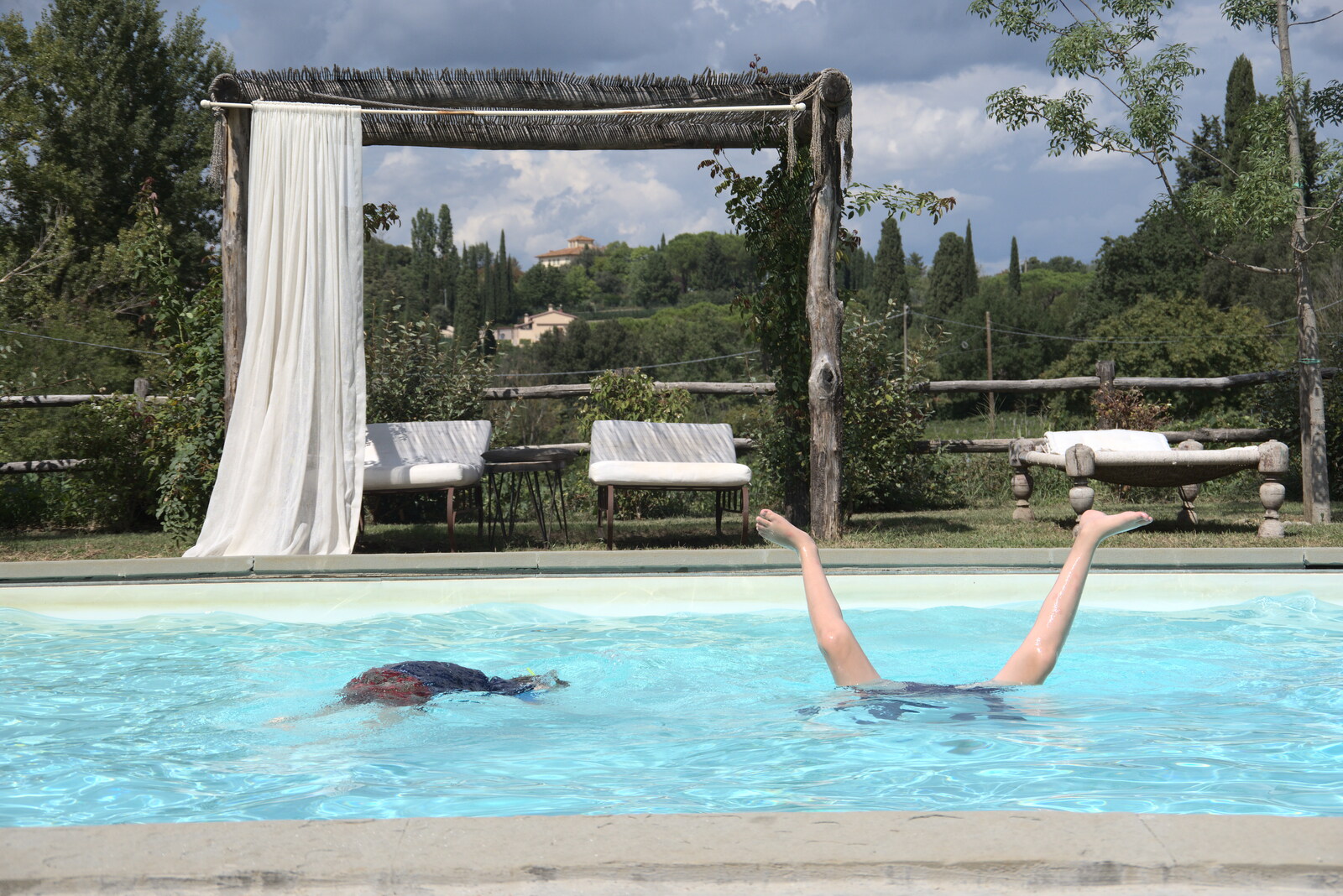 Castiglio Del Lago and Santuario della Verna, Umbria and Tuscany, Italy - 1st September 2022: Fred does hand stands in the swimming pool
