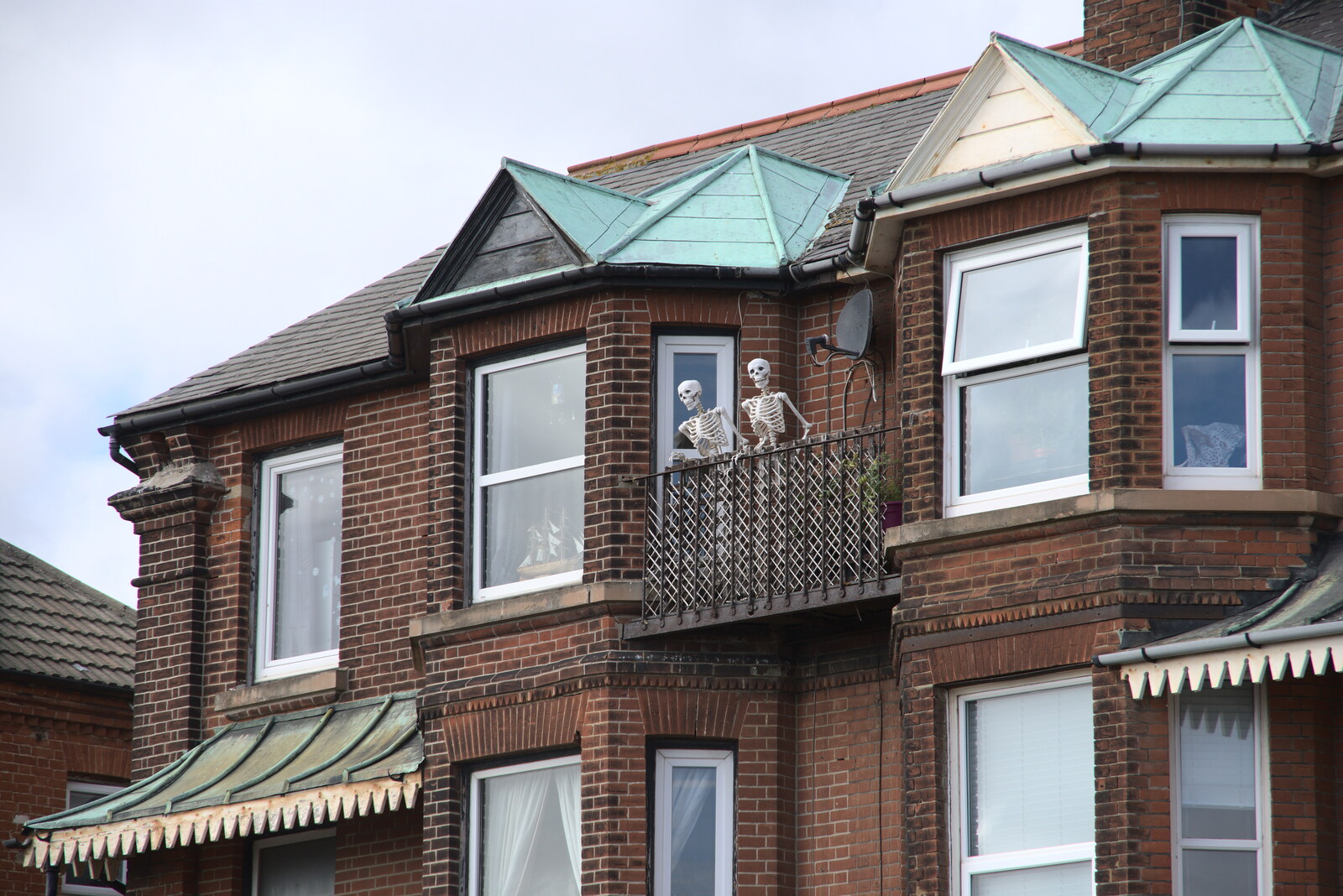 A Postcard from Felixstowe, Suffolk - 5th October 2022: A pair of skeletons look out from a balcony