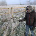 Fred pokes a frosty plant, A Frosty Walk Around Brome, Suffolk - 22nd January 2023
