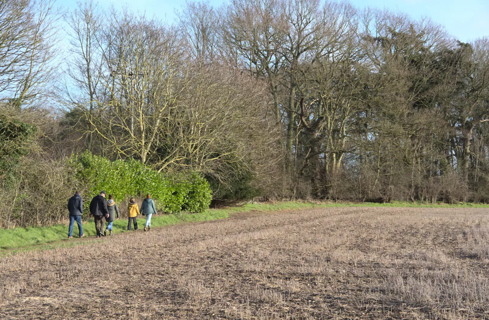 The walkers roam the edge of a field in Oakley, from Another Walk to The Swan, Hoxne, Suffolk - 5th February 2023