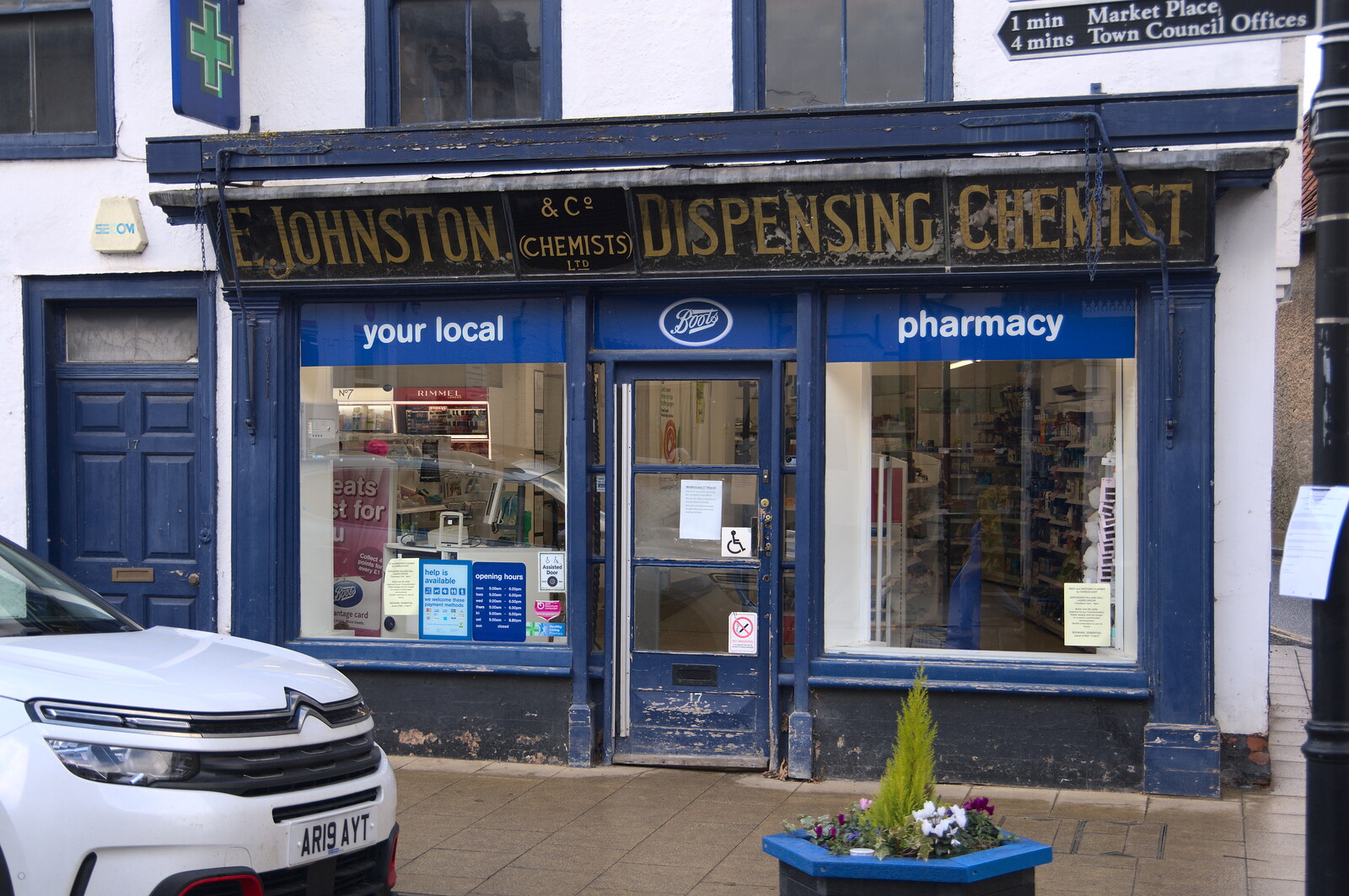 Lunch in Harleston, Norfolk - 1st March 2023: An E. Johnston Dispensing Chemist sign on a Boots