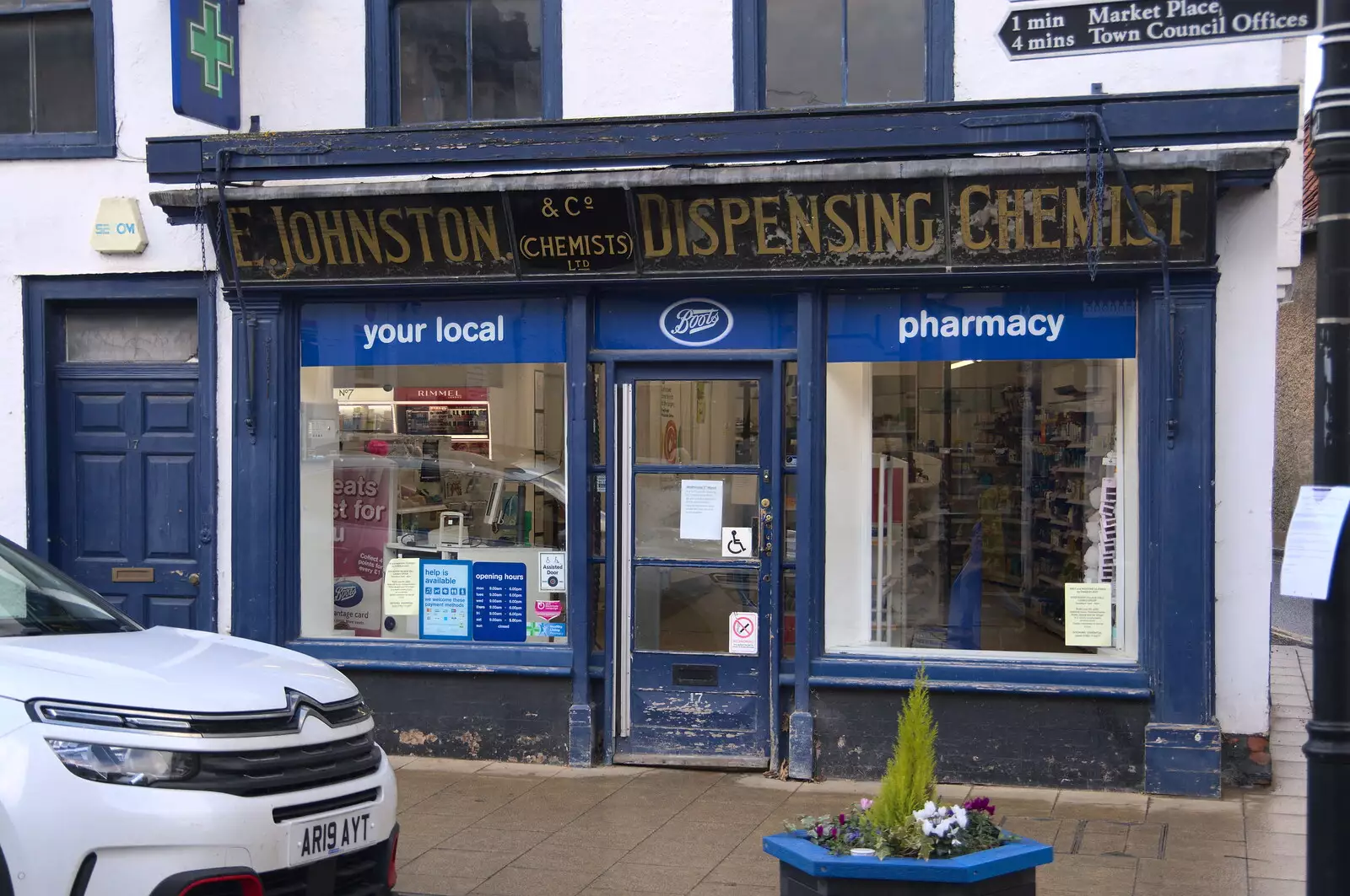 An E. Johnston Dispensing Chemist sign on a Boots, from Lunch in Harleston, Norfolk - 1st March 2023