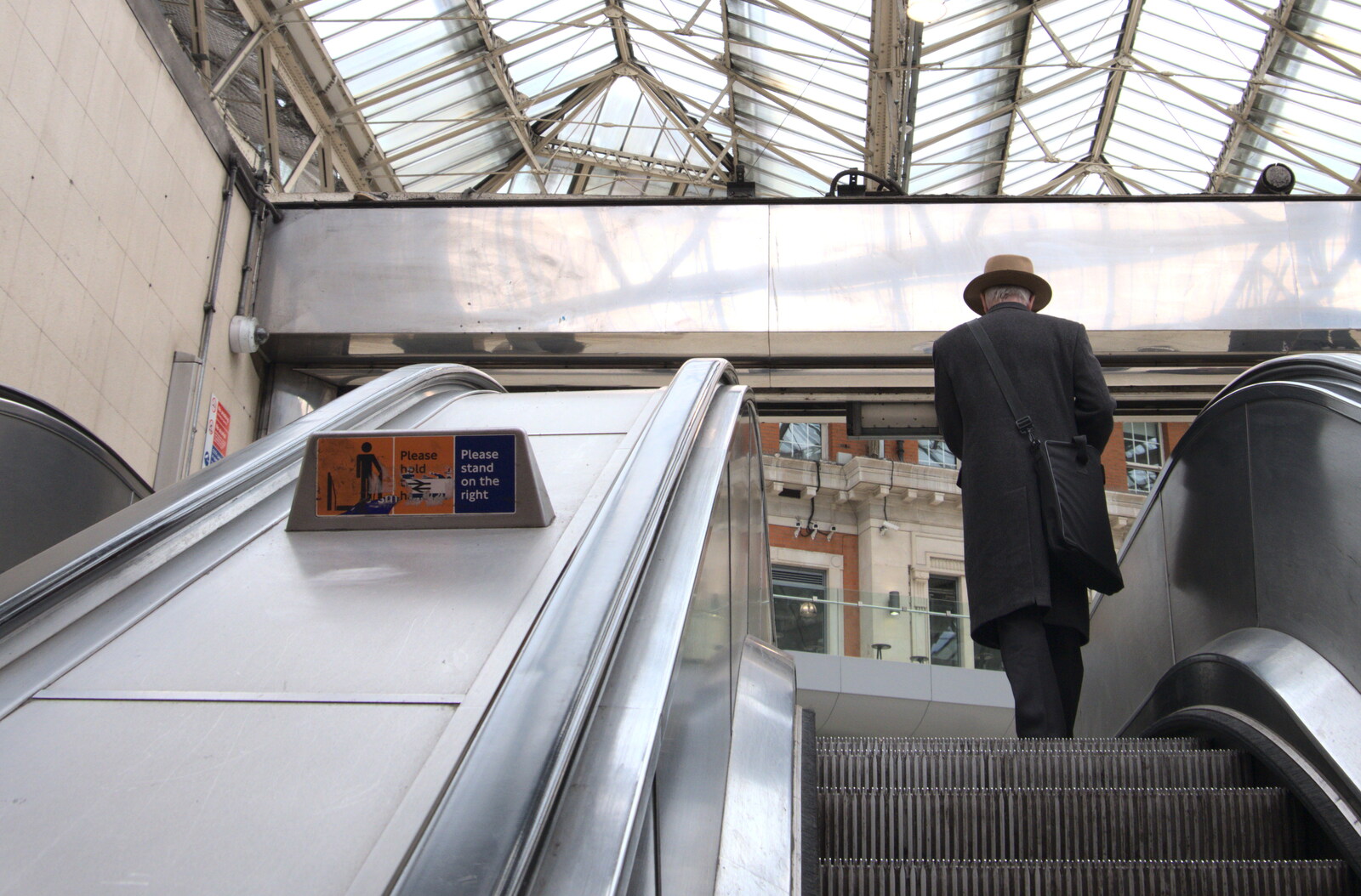 A dude in a hat on the escalator at Waterloo from A Day in New Milton, Hampshire - 3rd April 2023
