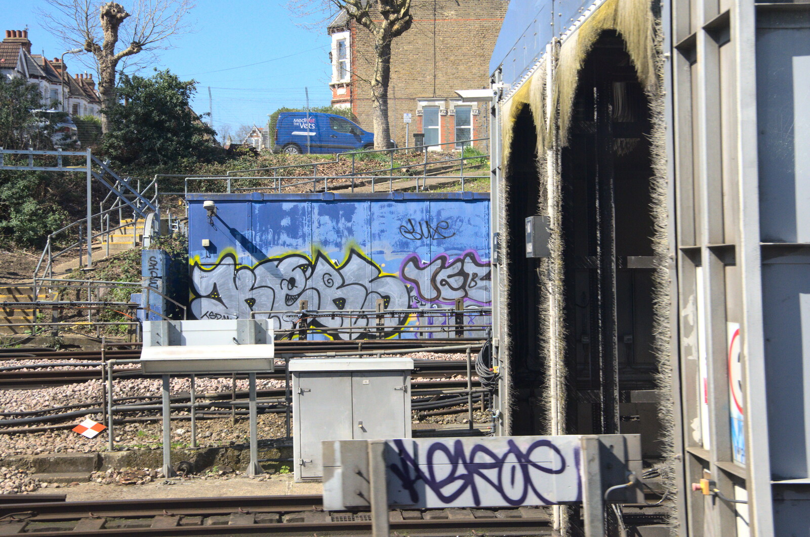 Sky-blue graffiti near a train wash from A Day in New Milton, Hampshire - 3rd April 2023