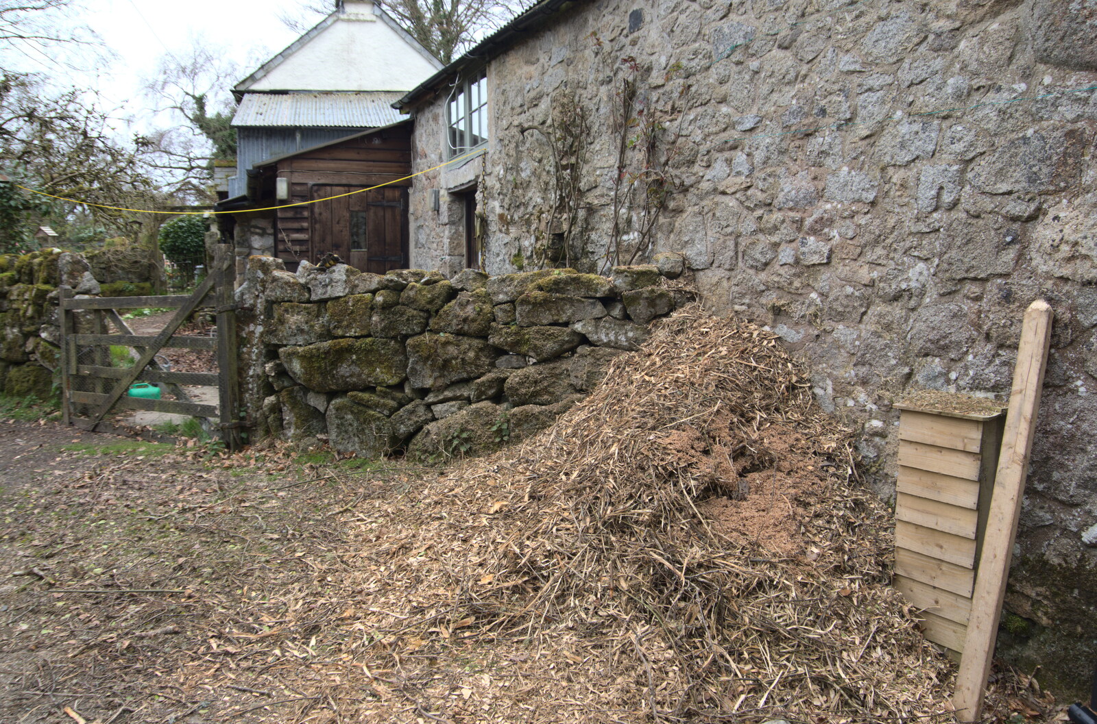 A pile of animal bedding by a cottage from Easter in South Zeal and Moretonhampstead, Devon - 9th April