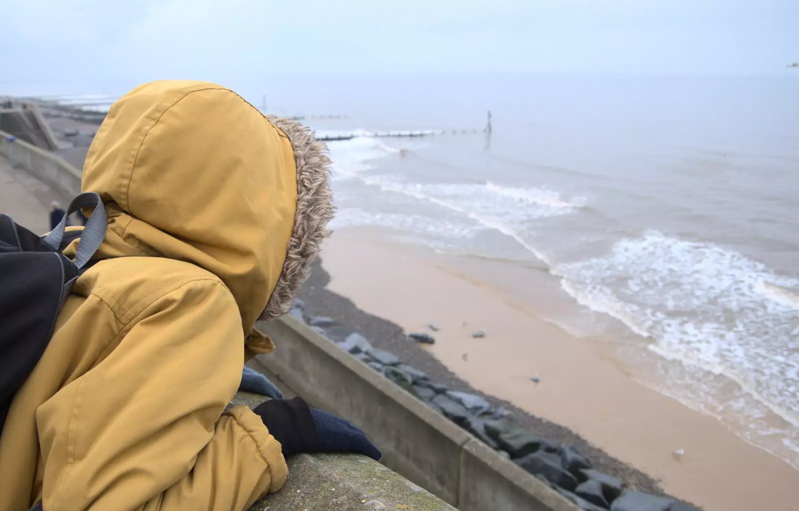 Harry peers over the wall at the sea, from A Coronation Camping Picnic, Kelling Heath, Norfolk - 6th May 2023