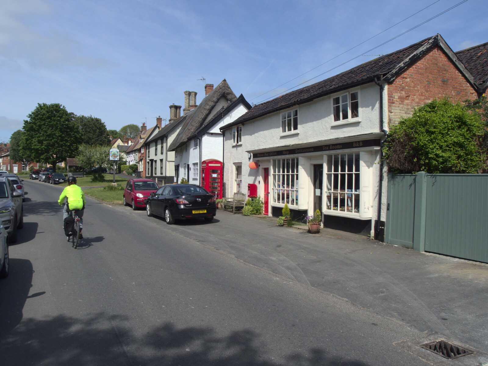 Isobel cycles up Low Street in Hoxne from A Quest for the Fabled Swimming Spot, Hoxne, Suffolk - 29th May 2023