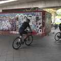 A couple of cyclists whizz past some graffiti, A Walk To The Rheinturm, Düsseldorf, Germany - 29th July 2023
