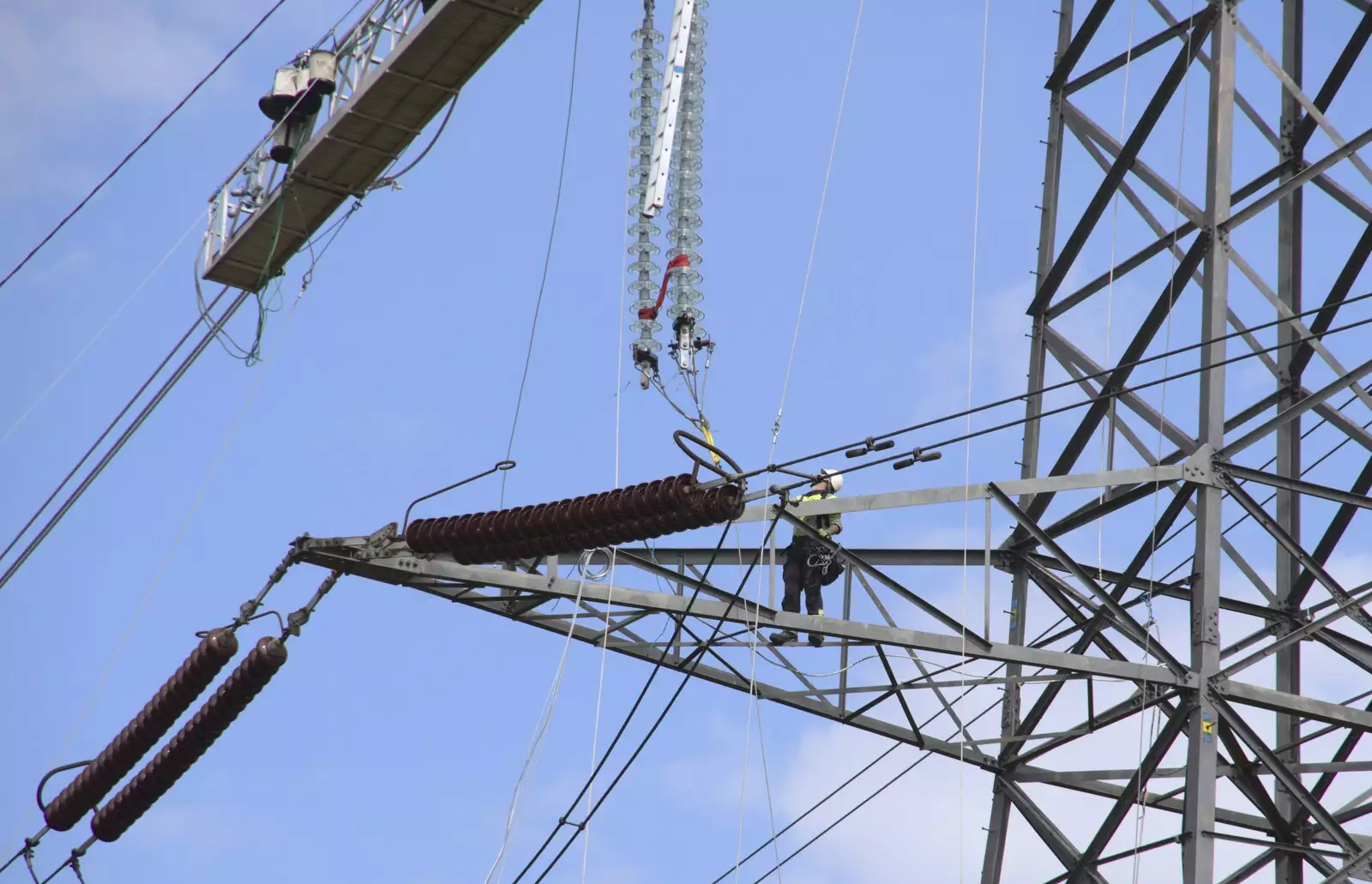 A dude looks up at some new insulators, from National Grid Pylon Upgrades, Thrandeston, Suffolk - 30th July 2023