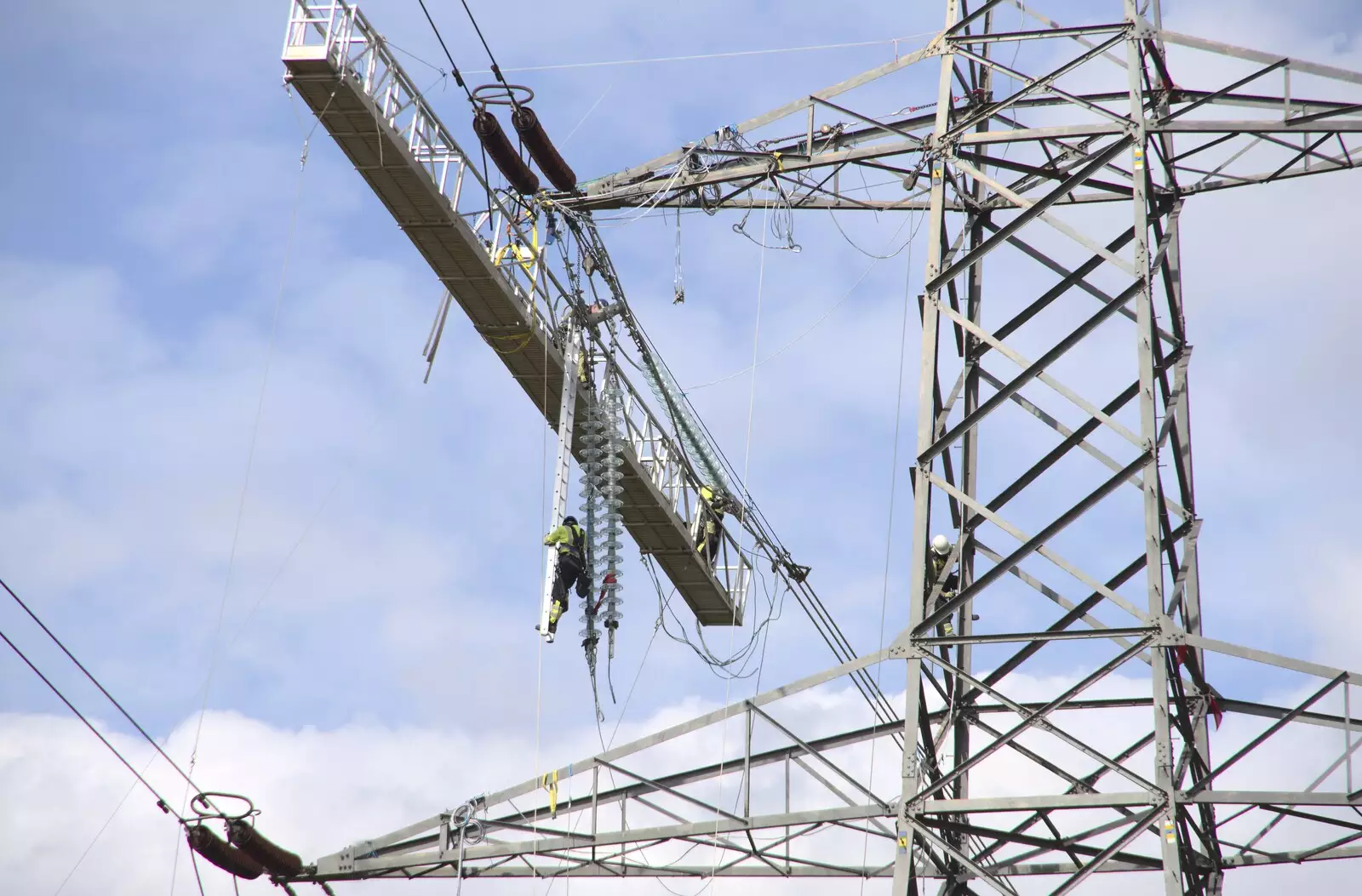 Someone dangles on a ladder by the insulators, from National Grid Pylon Upgrades, Thrandeston, Suffolk - 30th July 2023