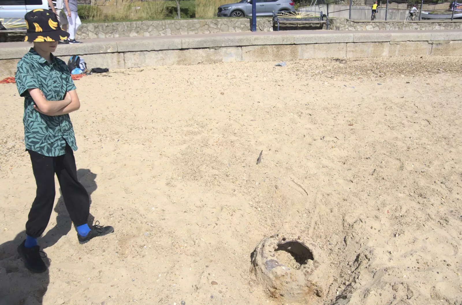 Harry considers a lump of iron in the beach, from A trip on the Ferris Wheel, Felixstowe, Suffolk - 15th August 2023