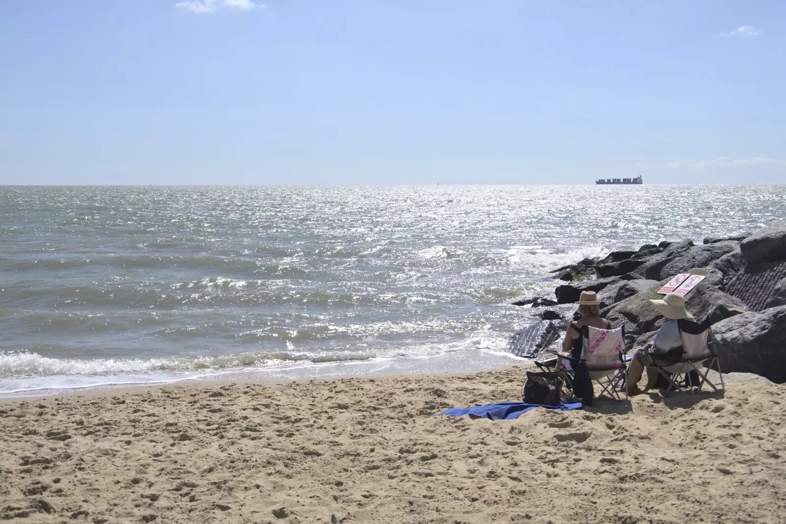 A couple sit on the beach and read, from A trip on the Ferris Wheel, Felixstowe, Suffolk - 15th August 2023