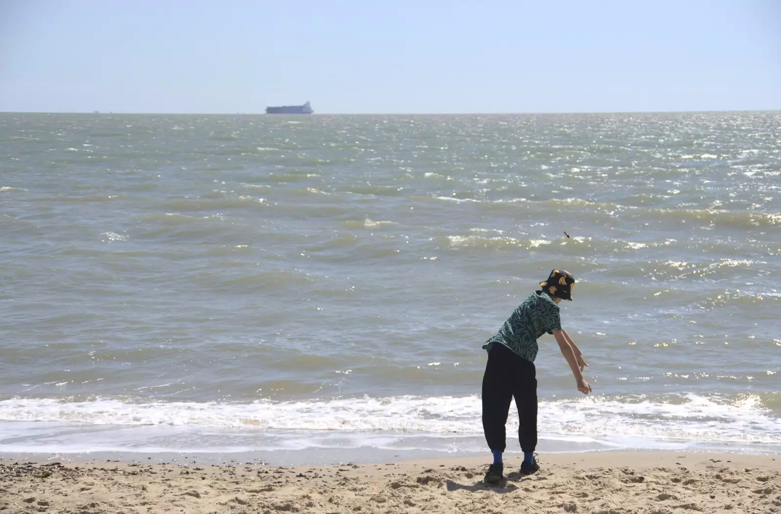 Harry flings some stones into the sea, from A trip on the Ferris Wheel, Felixstowe, Suffolk - 15th August 2023