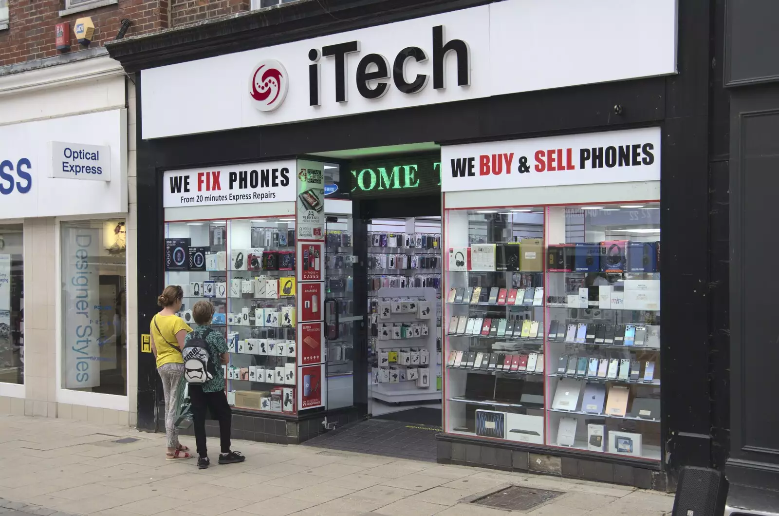 Isobel and Harry look in a dodgy phone shop, from Shoe Shopping in Norwich, Norfolk - 16th August 2023