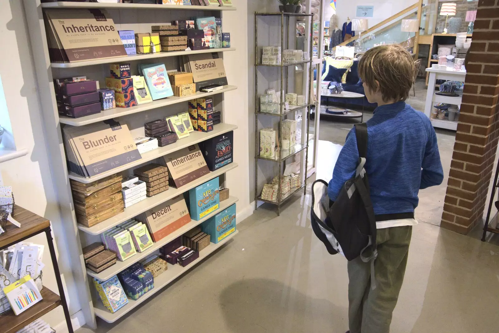 Harry looks at games in the fancy home shop, from Fred and the SYWO at Snape Maltings, Snape, Suffolk - 3rd September 2023