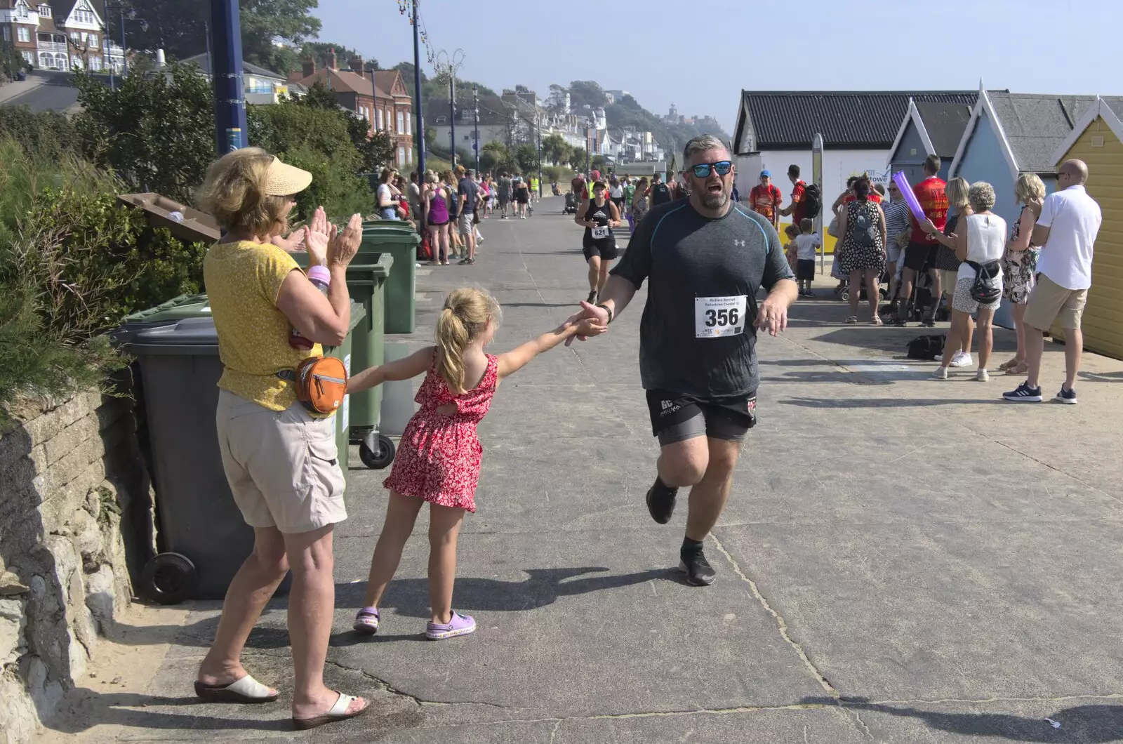 A runner gets a High Five, from A Postcard From Felixstowe Ferry, Suffolk - 10th September 2023