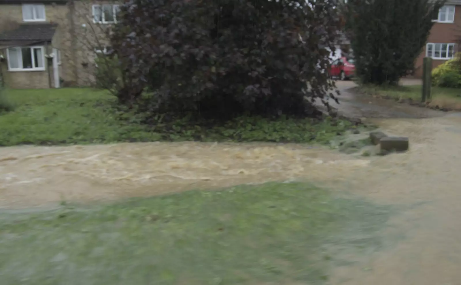 Water surges past houses in Wattisfield, from Tales From The Floods, Bury St. Edmunds and Walsham Le Willows, Suffolk - 20th October 2023