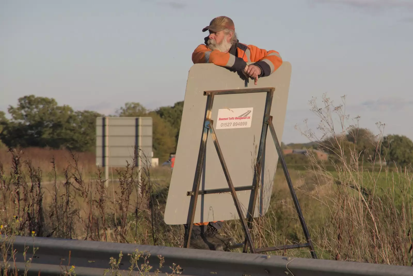 Some dude hangs off a road-closure sign, from A Giant Load on the A140, Yaxley, Suffolk - 22nd October 2023