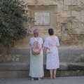 Two women look at a wall inscription, The Cats of Rhodes, Ρόδος, Greece - 24th October 2023