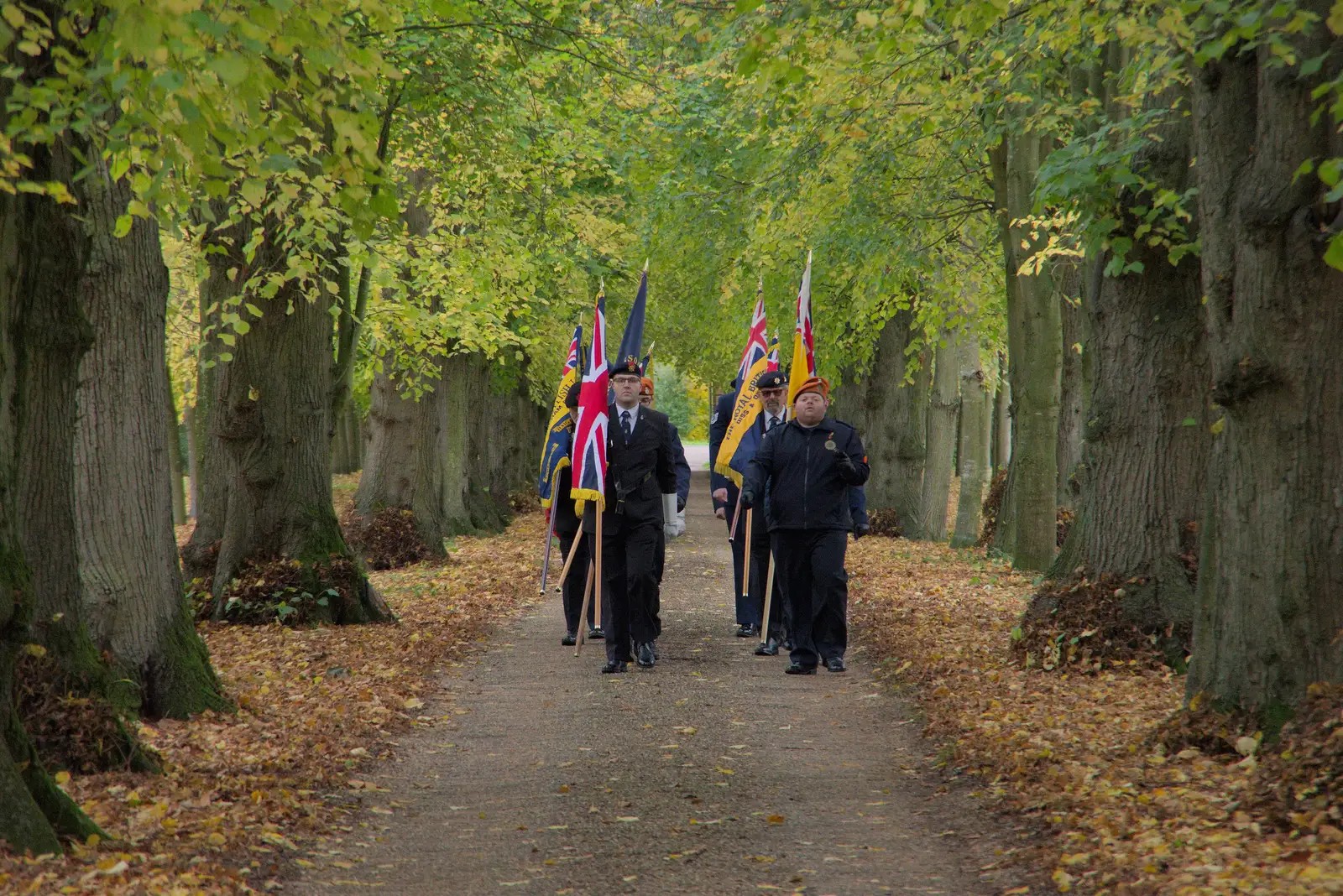 Flag bearers march up the Oaksmere's avenue, from A B-17 Memorial, The Oaksmere Hotel, Brome, Suffolk - 10th November 2023