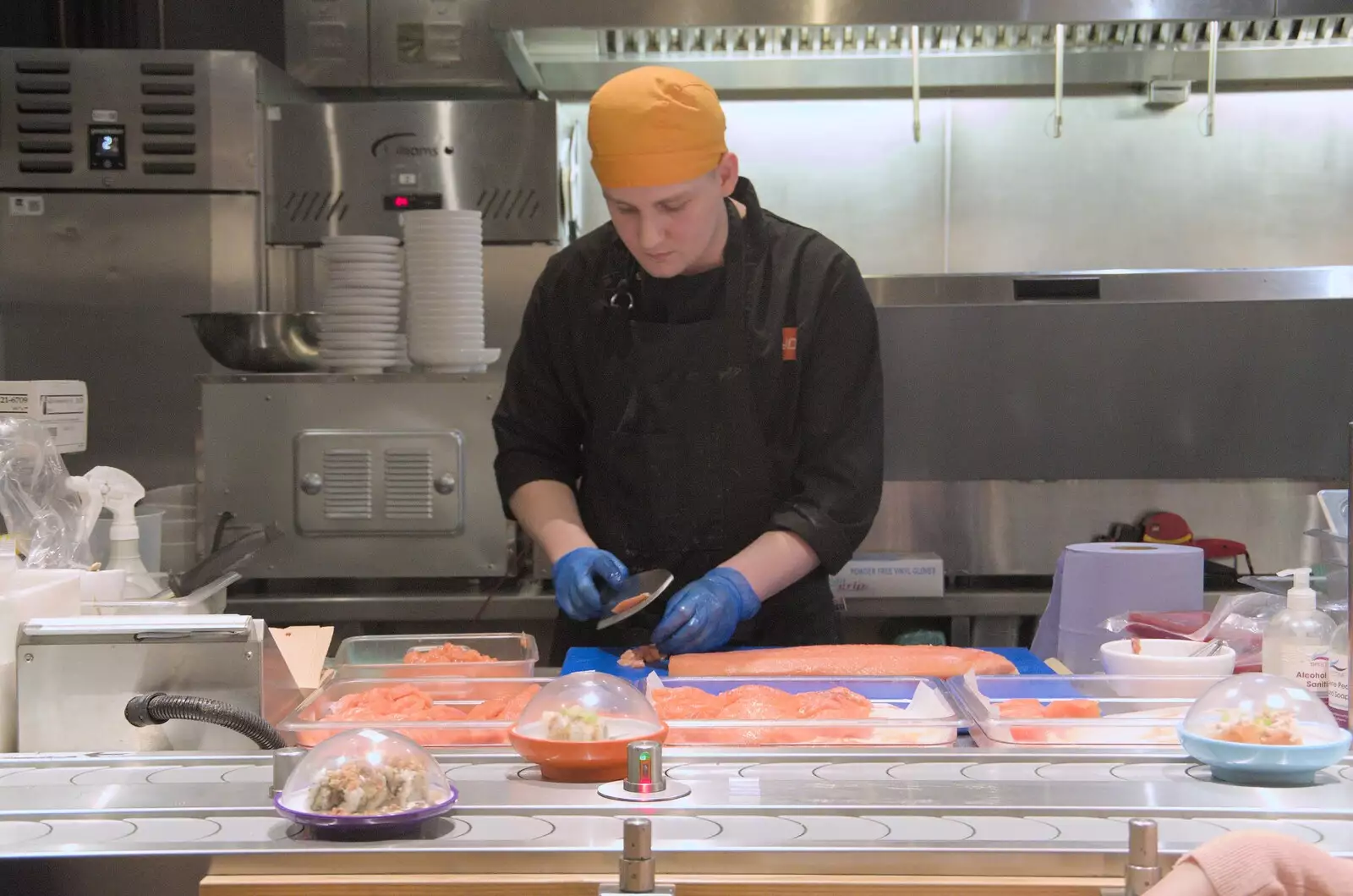 A dude in Yo! Sushi slices salmon fillets, from Norwich Sushi and Pantomime Rehearsals, Occold, Suffolk - 7th January 2024