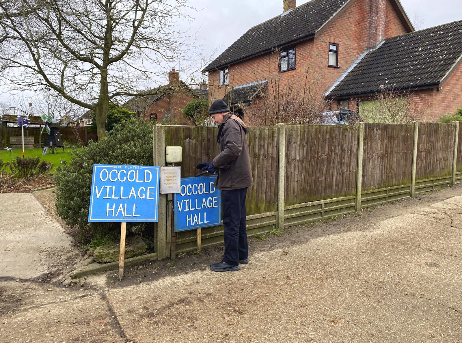 We stick one of the signs up by the village hall from The Dove Players do Puss in Boots, Occold, Suffolk - 13th January 2024