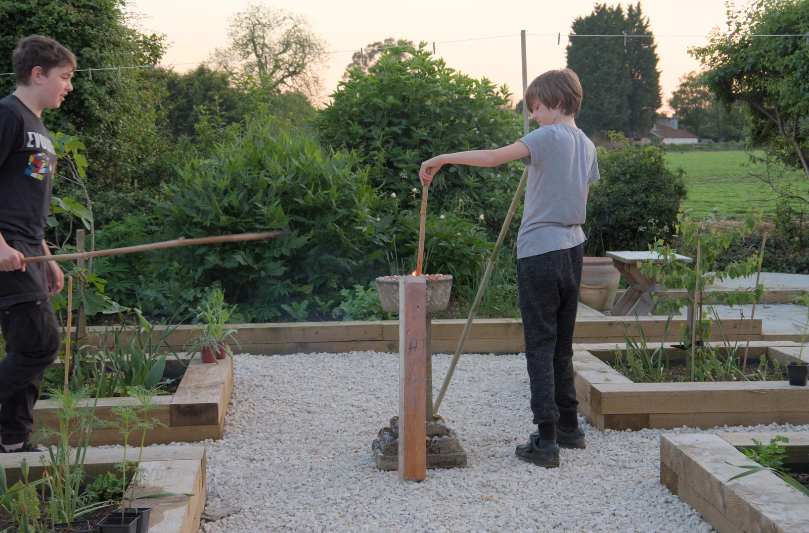 Harry pokes his stick into some old tealights, from The Village Hall Plant Sale, and a New Dinghy, Weybread, Norfolk - 19th May 2024