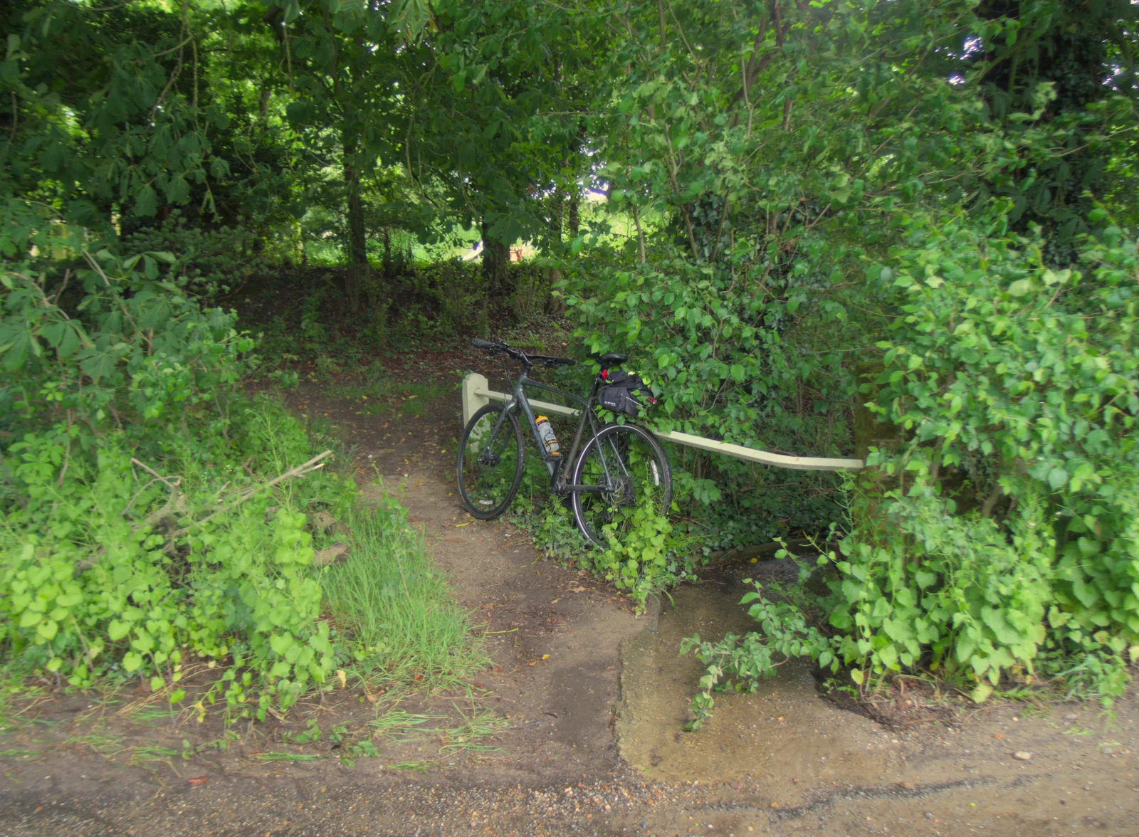 The bike waits by a brook, from A Trip to Beccles, and the BSCC at The Greyhound, Botesdale, Suffolk - 23rd May 2024