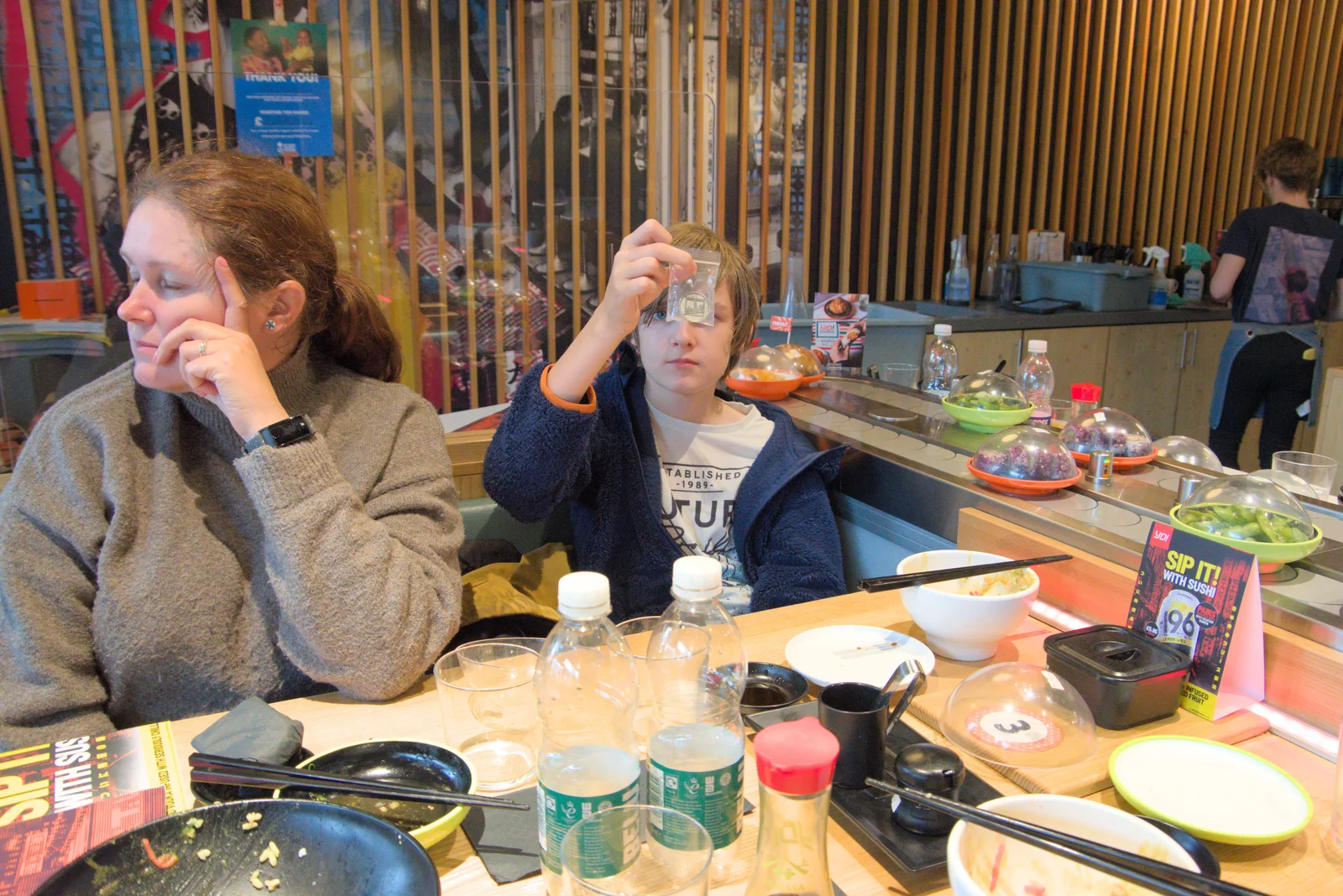 Harry holds up his Warhammer coin in Yo! Sushi, from Birthday Shopping in the Rain, Norwich - 25th May 2024