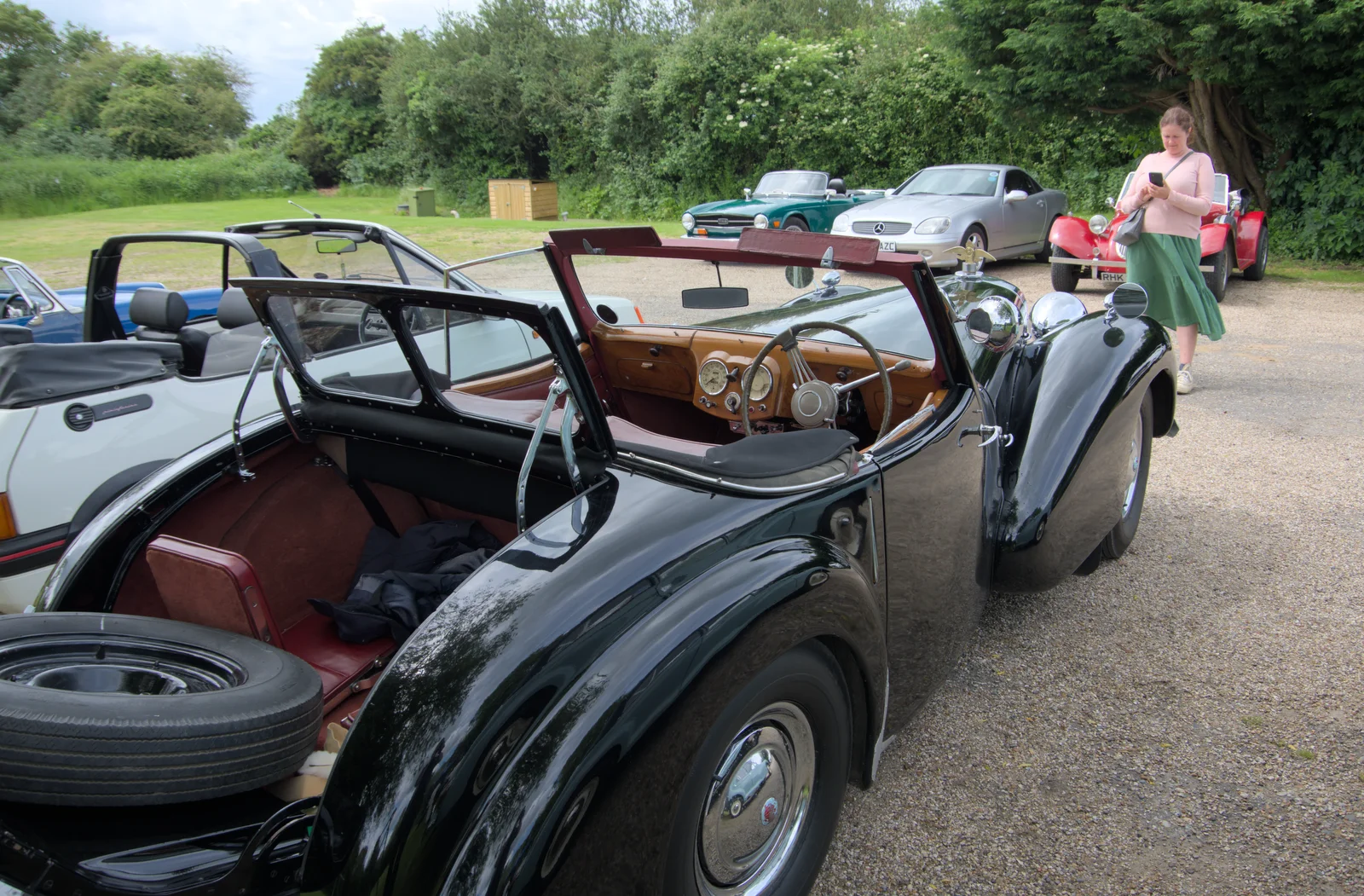 Isobel takes a photo of a lovely roadster, from Saxtead Mill, Framlingham Gala and Chips on the Beach, Aldeburgh - 27th May 2024