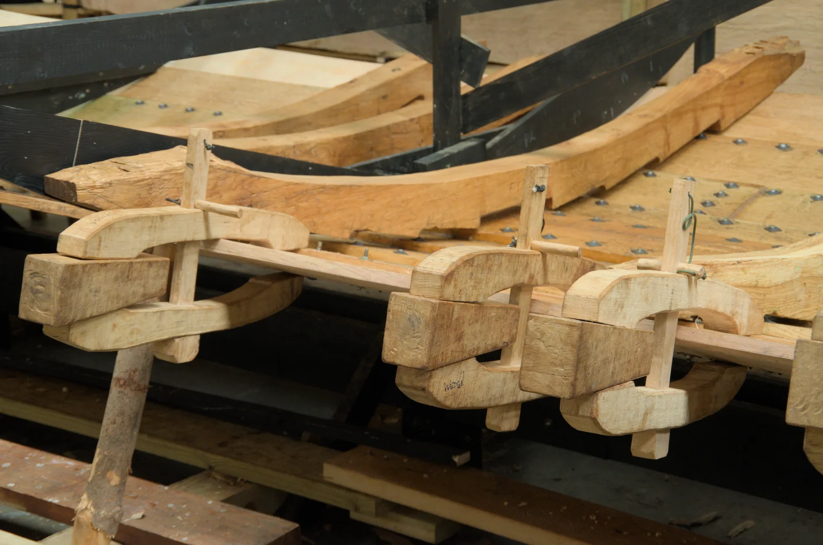 Wooden clamps hold a strake in place, from The Sutton Hoo Ship Reconstruction, The Longshed, Woodbridge - 29th May 2024