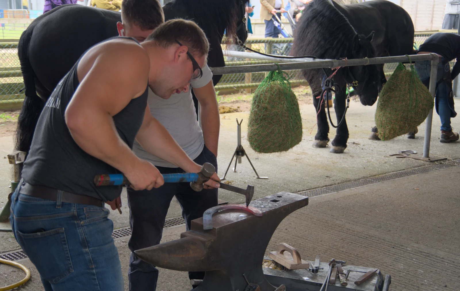 Hammering holes into a horseshoe, from Fred and the SYWO at the Suffolk Show, Trinity Park, Ipswich - 30th May 2024