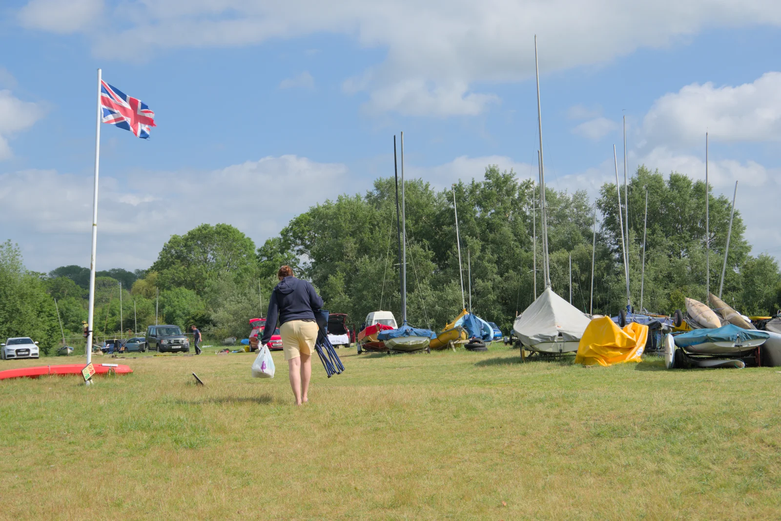 Isobel wanders off with a folding chair, from Sailing at the Lake, and the GSB at Mellis, Suffolk - 6th June 2024