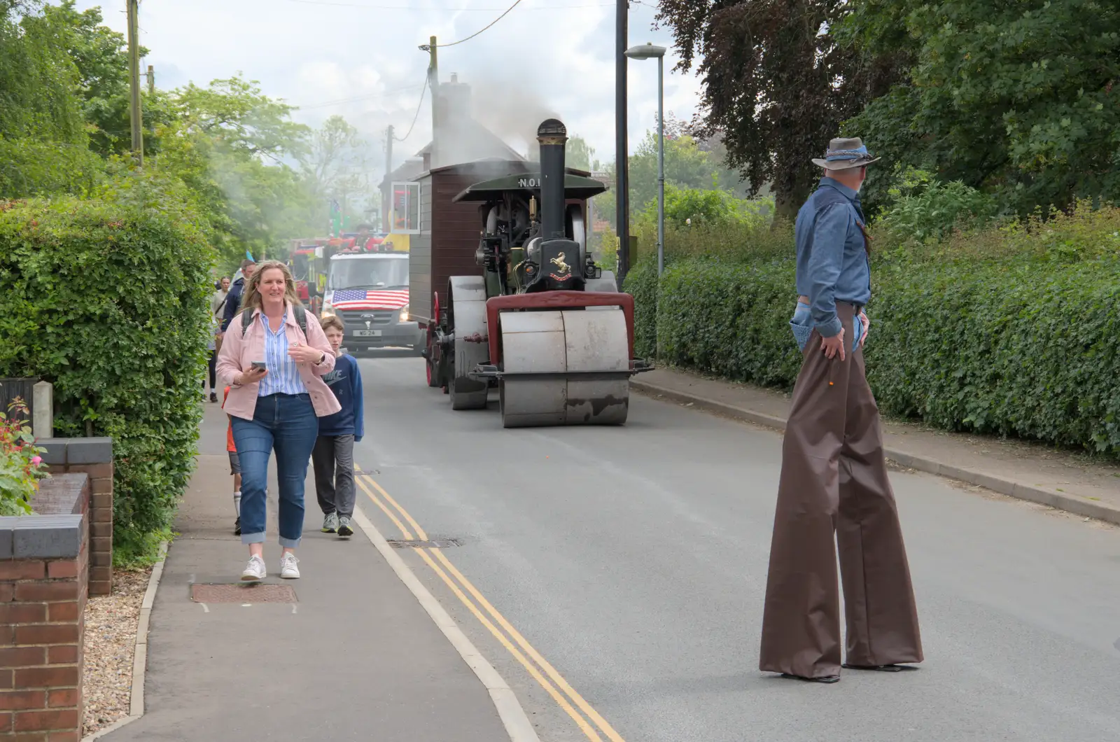 A dude on stilts looks back, from The Carnival Procession, Diss, Norfolk - 16th June 2024