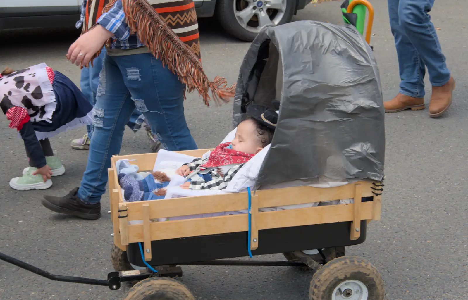 A baby sleeps through it all, from The Carnival Procession, Diss, Norfolk - 16th June 2024