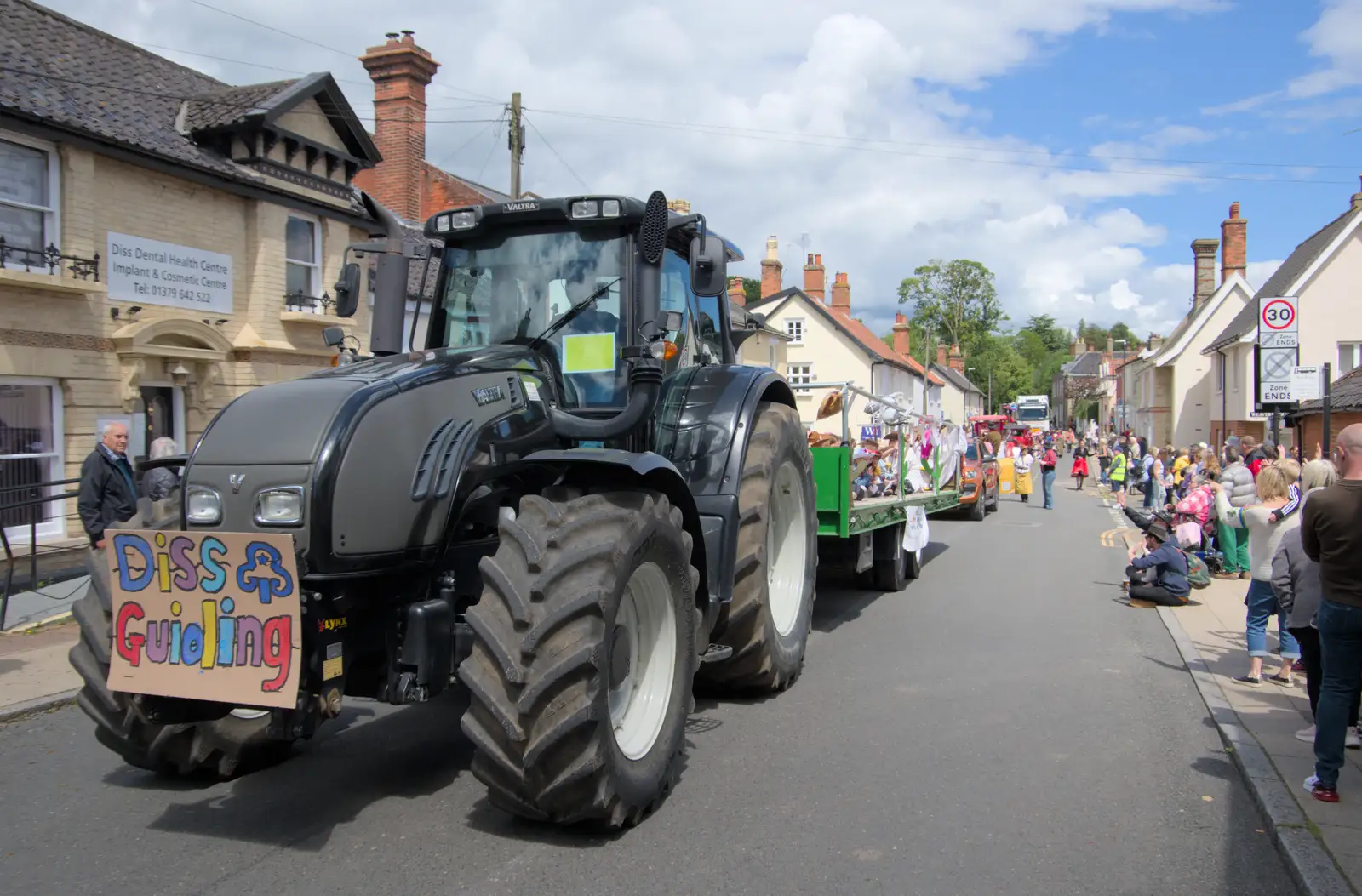 A giant tractor pulls the Diss Guiding float, from The Carnival Procession, Diss, Norfolk - 16th June 2024