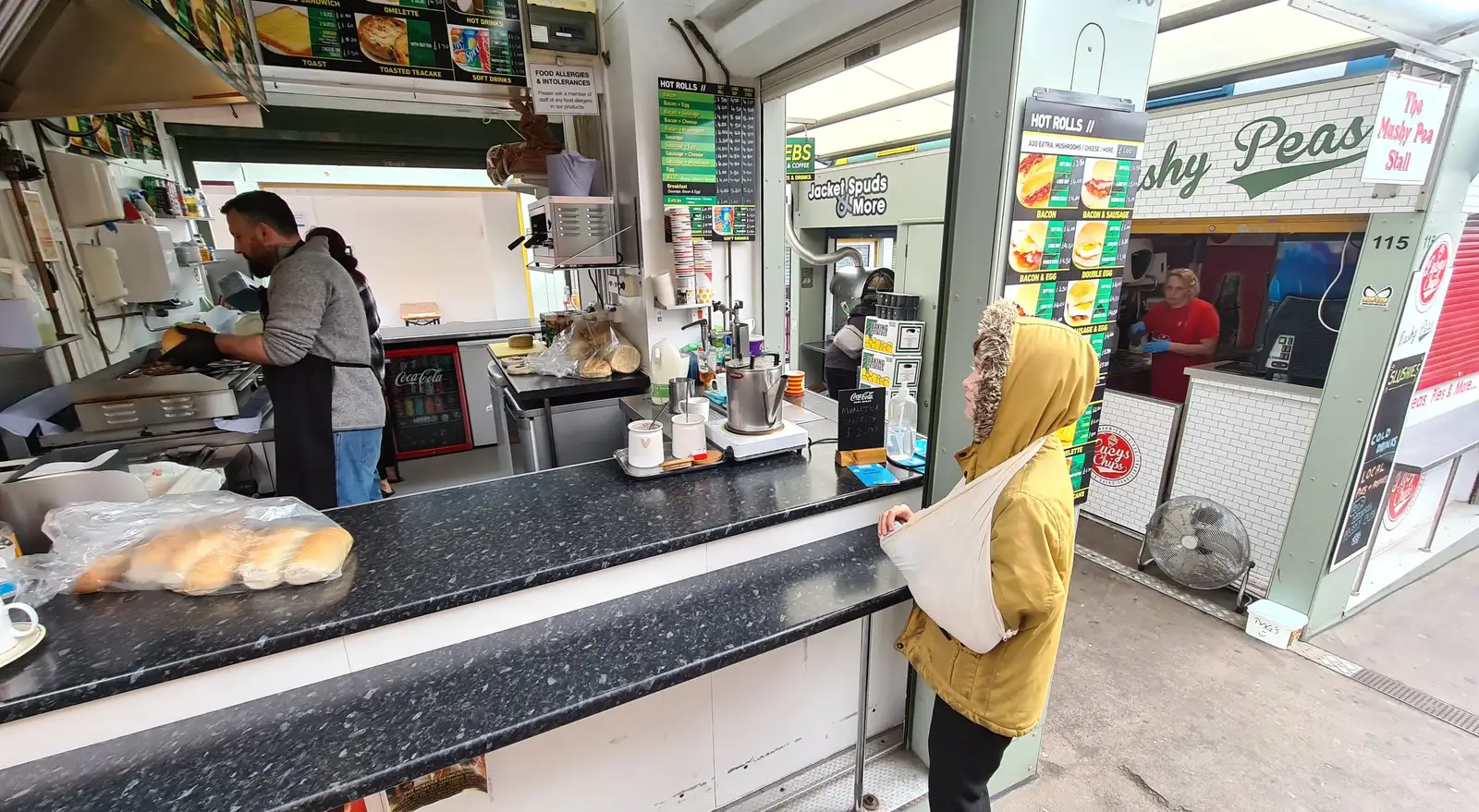 Harry waits for a bacon bap in Norwich market, from Eye Karate Kamp, Southwold Harbour, Suffolk - 6th July 2024