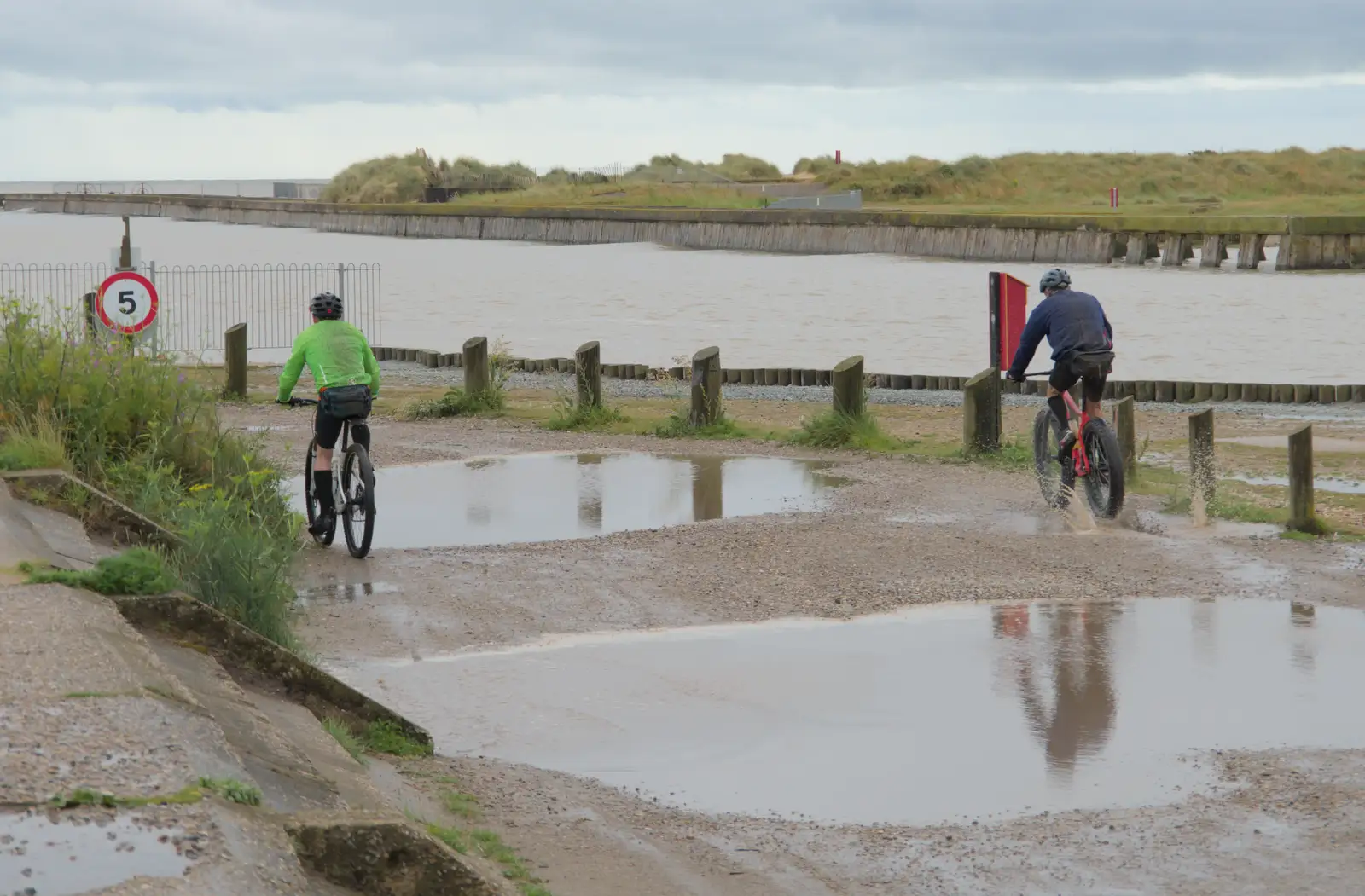 A couple of cyclists roar past, from Eye Karate Kamp, Southwold Harbour, Suffolk - 6th July 2024