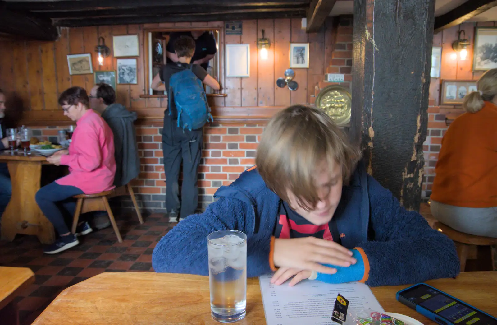 Harry scopes out the menu in the Harbour Inn, from Eye Karate Kamp, Southwold Harbour, Suffolk - 6th July 2024