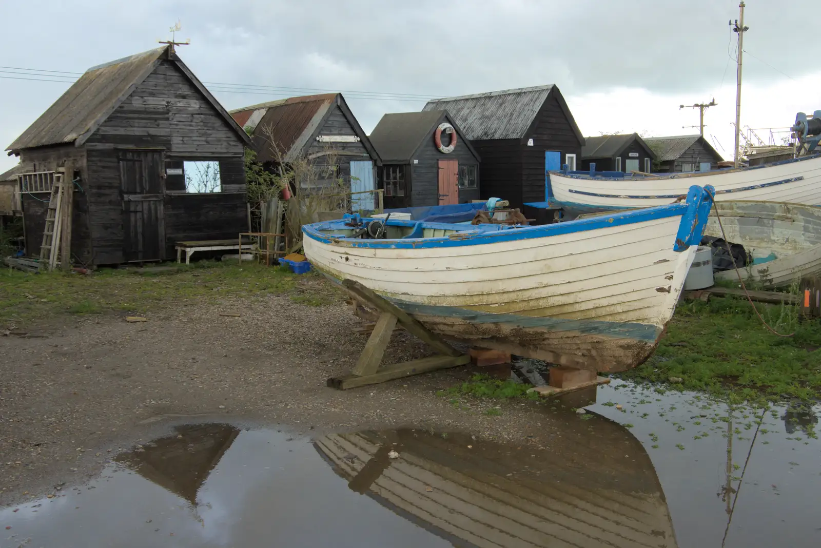 A boat is reflected in a puddle, from Eye Karate Kamp, Southwold Harbour, Suffolk - 6th July 2024