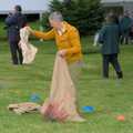 Pippa lays out sacks for the sack race, The Brome and Oakley Village Fête, Brome Hall, Suffolk - 13th July 2024