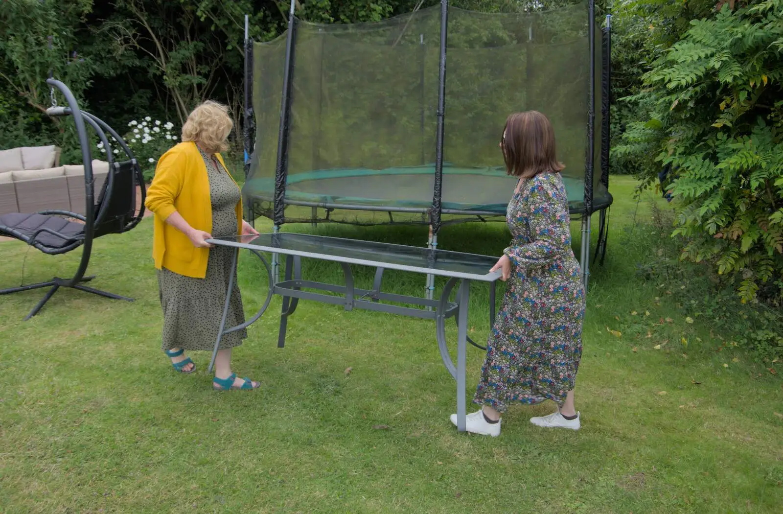 Megan and Sarah move a table around, from Lane's End Festival, Bressingham, Norfolk - 14th July 2024